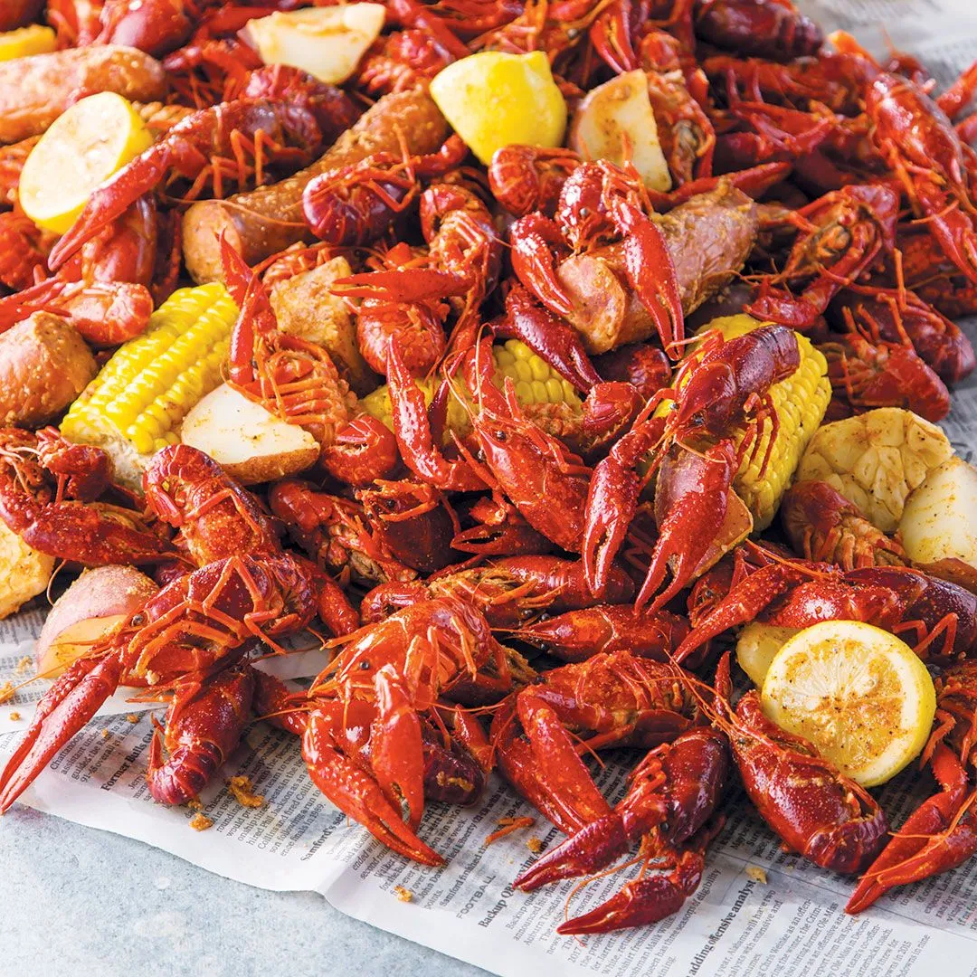 A generous crawfish boil with corn, lemon, and herbs